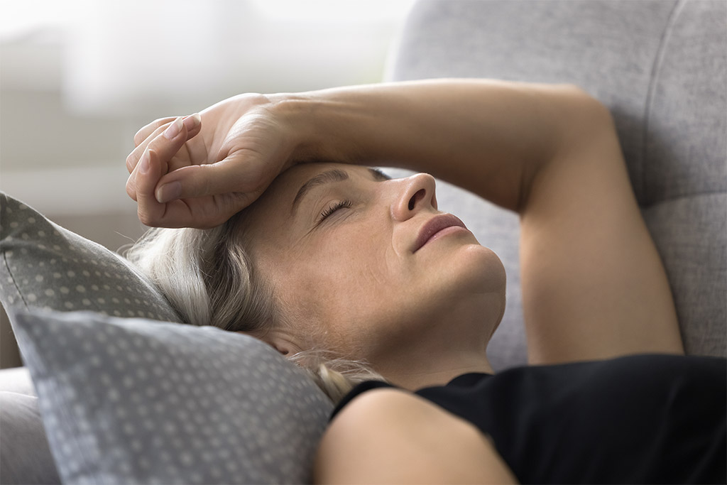 low-energy-fatigue-menopause-woman-arm-on-forehead-1024x863 Menopausal fatigue and low energy is represented by a closeup of a white woman lying down with eyes closed and arm resting on forehead