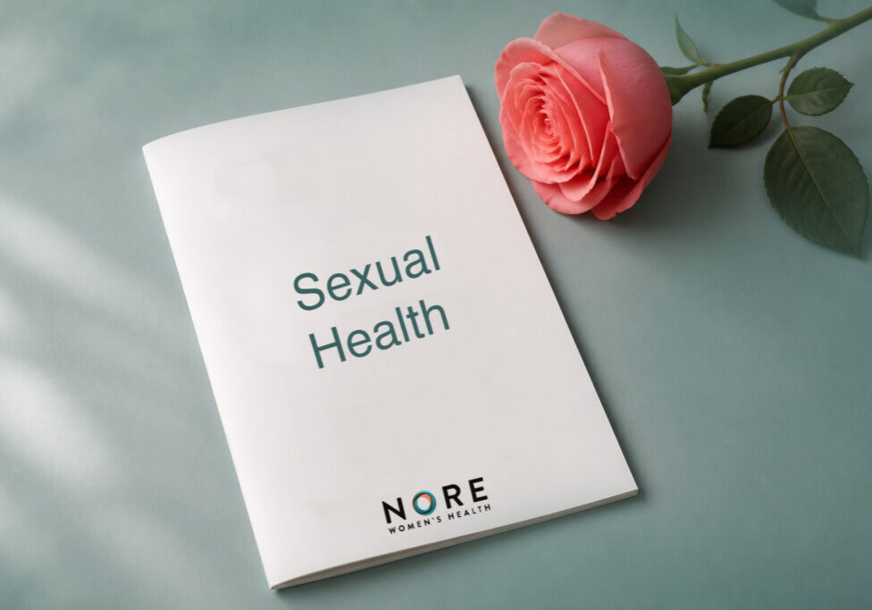 Illustration representing women's sexual health education and resources, featuring a booklet cover, rose flower, and Nore Women's Health branding.